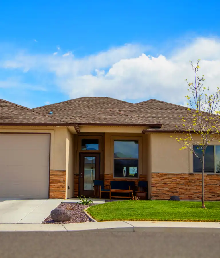 House With Stacked Stone And Tan Stucco Portrait